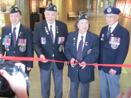 WWII veterans (from left to right) Ed Lee; George Chow, Peggy Lee and Frank Wong cut the ribbon the the One War, Two Victories exhibition.