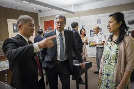 Chinese Cultural Centre board chair Fred Kwok, chats with William Kwok and Christine Faron Chan about one of the new exhibits.