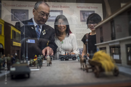 Military historian and museum member Trevor Sam explains the story behind a model to family members. 