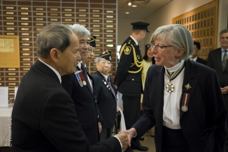 WWII veteran Tommy Wong meets Lieutenant Governor Judith Guichon while another WWII veteran, Peggy Lee, looks on. 