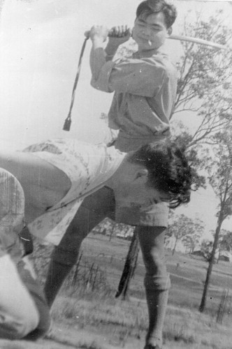 Louey King pretends to behead his friend Eddie Chow. (Australia 1945)