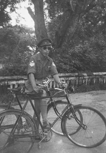 Donald Sung (Force 136 India) on his bicycle and holding the bike of his cousin Young Ming (James) Wong. 