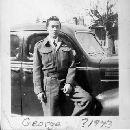 George SL Wong stands next to car. Likely shot in Canada circa 1943.